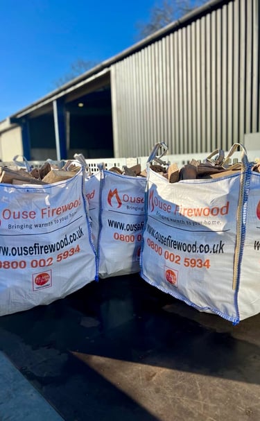 Kiln dried hardwood logs in 0.65m3 dumpy bags with Ouse Firewood branding in Cambridgeshire
