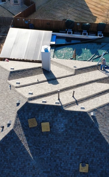 overhead shot of a roof replacement with great care being taken for customers property, pool covered