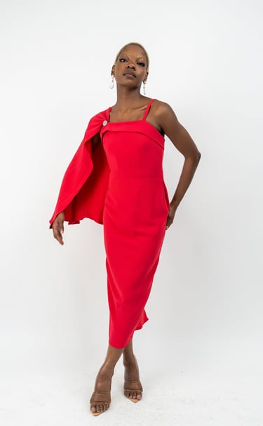 a woman in a red dress and a red capelet