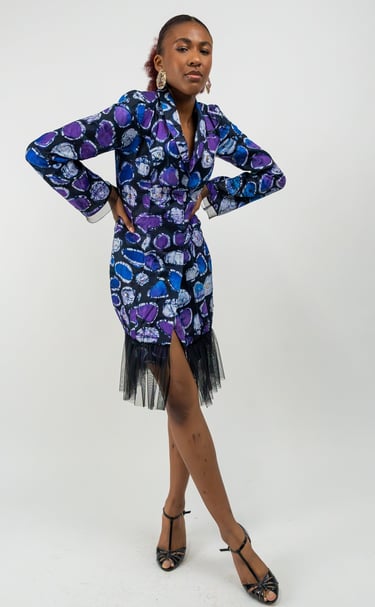 a woman in a blue dress with a black trims