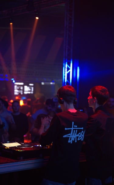 a dj spinning around in a nightclub