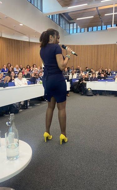 a woman in a blue dress standing in front of a crowd of people