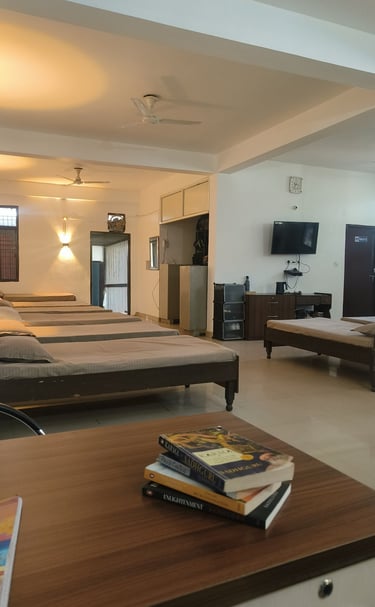 Spacious open-concept residential ward at Mehar Rehabilitation with wooden beds, clean linens.
