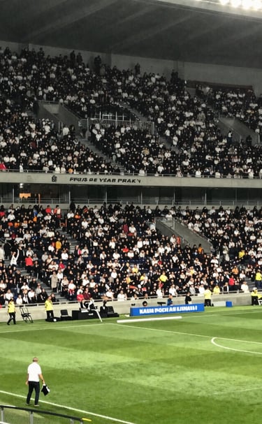 Streetwear look featuring a bold soccer jersey paired with sneakers and urban backdrop.
