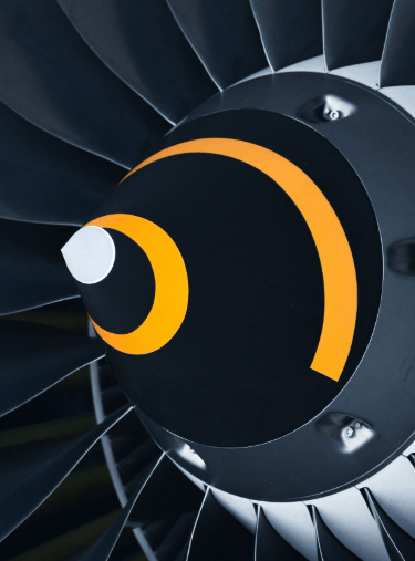 Close-up view of an airplane turbine engine, showcasing the intricate metal blades within the engine