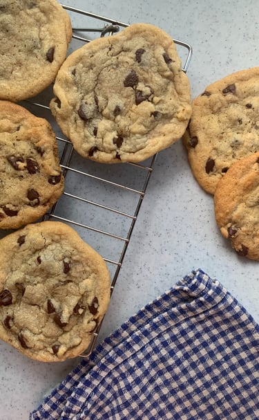 freshly baked sugar cookies displayed before a farmers market selling assorted baked goods