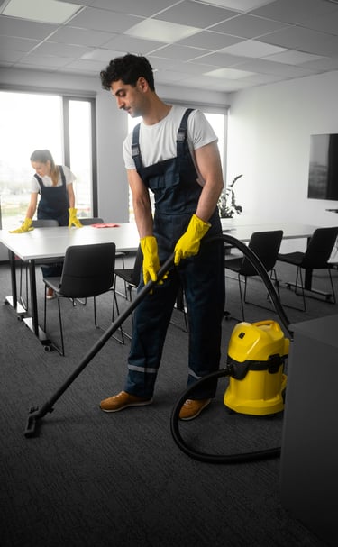 a man in overall cleaning a room