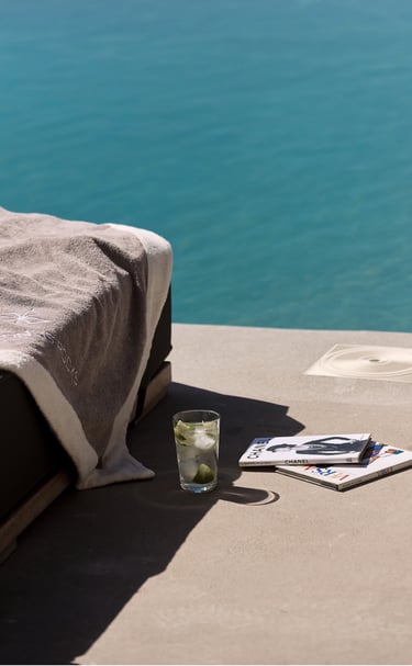 a bed with a book and a glass of water