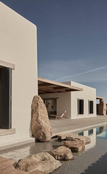 a large rock in front of a house
