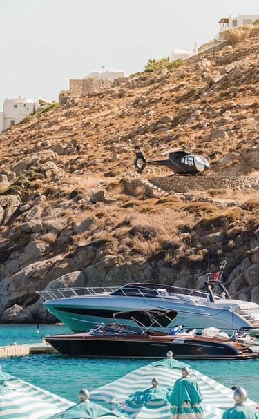 a helicopter helicopter hovers over a boat in the water
