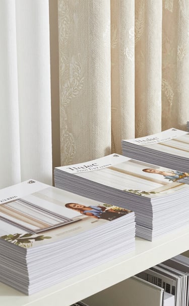 Elegant layered curtains in warm earth tones framing a large window with garden views.