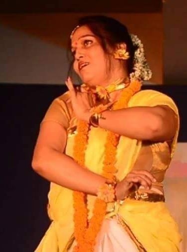 Mrs. Chaitali Biswas guiding students through a classical dance pose in a lively rehearsal