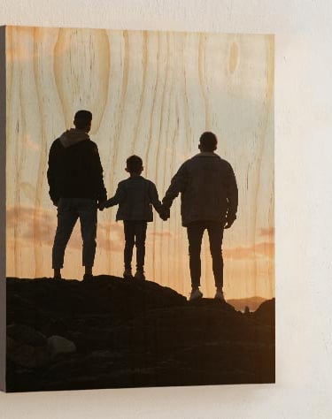 Custom family photo printed on wood wall art featuring a silhouette at sunset.
