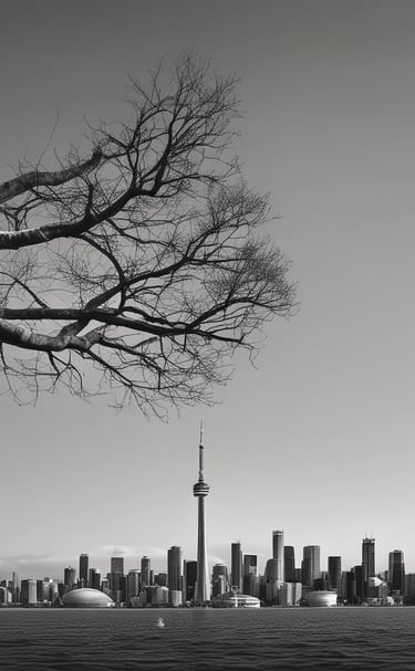 A modern building with a teal-green glass facade, positioned at an angle against a partially cloudy sky. The building has numerous windows and a Canadian flag is mounted at the top.