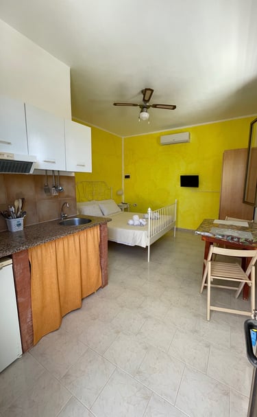 a kitchen with a bed and a kitchen