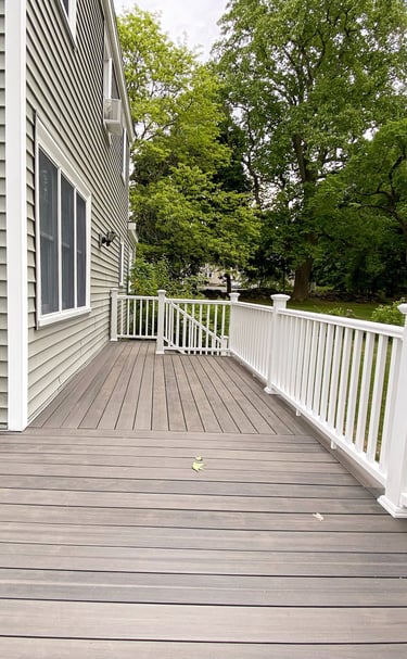 a custom pvc deck with a white hand rails