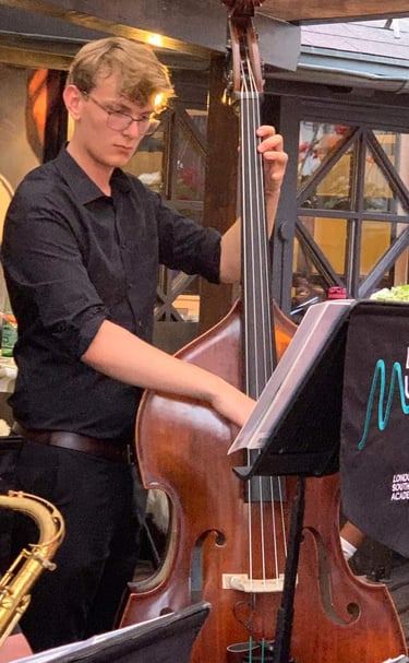 An image of Jamie Walker performing jazz on his double bass