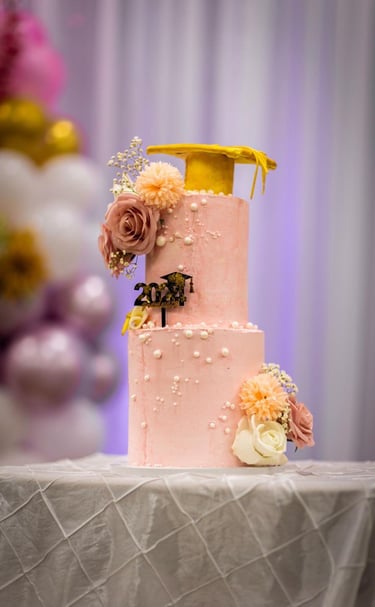 a cake with a yellow ribbon and flowers on it