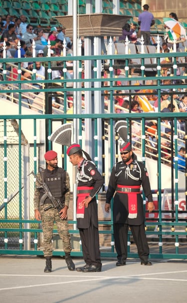Three men in ceremonial uniforms standing proudly at Wagah Border, showcasing patriotism and nationa