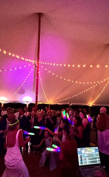 a group of people dancing in a tent