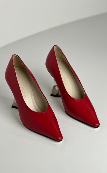 Judy Mazzotti pair of red shoes with a white background