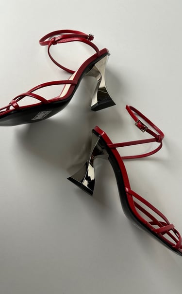 Judy Mazzotti pair of red shoes with a pair of heels