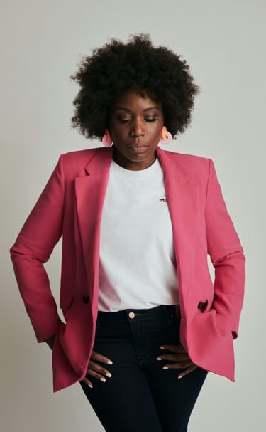 Black woman in a pink jacket and jeans