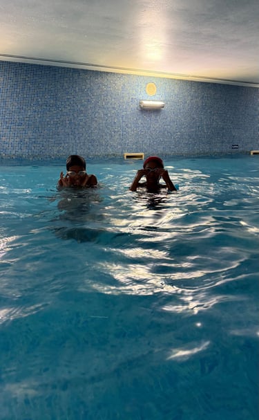 two kids in a pool w goggles
