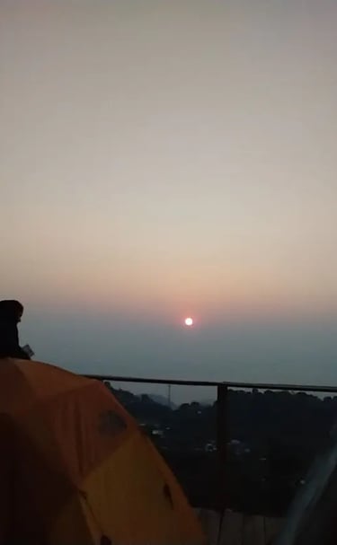 a person sitting on a tent with a tent