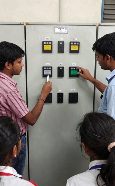 Students working intently on a PLC programming setup in a modern lab.