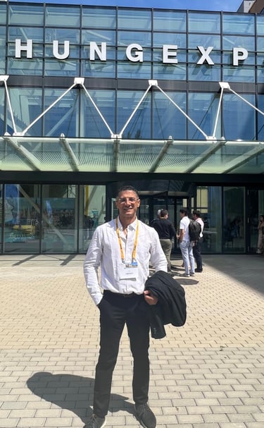 Professional attendee standing in front of the HUNGEXPO Budapest Congress and Exhibition Centre entrance.