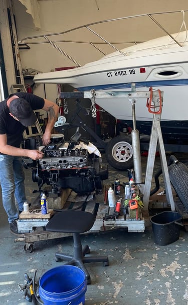Replacing spark plugs on a Mercury outboard engine near Welland.
