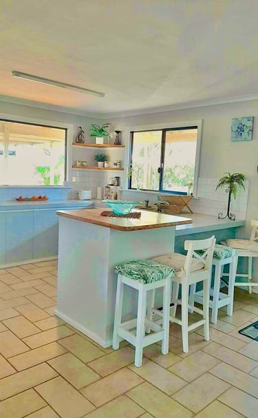 a kitchen with a large island bench and views!