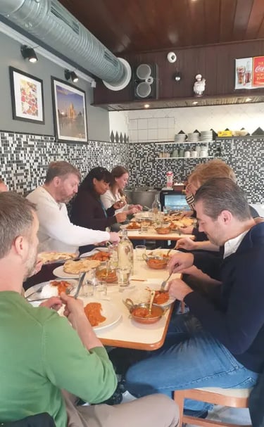 A group of friends dining together and enjoying authentic Indian cuisine at a local restaurant.