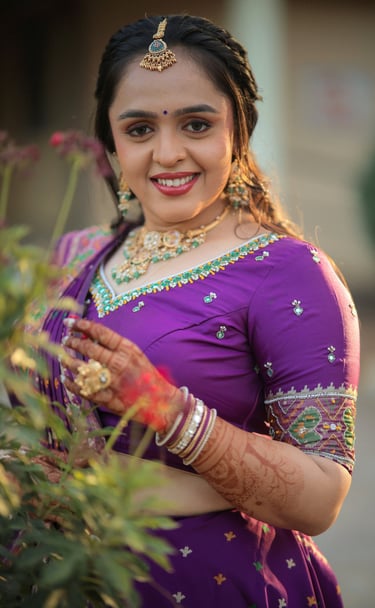 "Smiling Indian bride with traditional bridal makeup, maang tikka, and purple lehenga saree in outdo