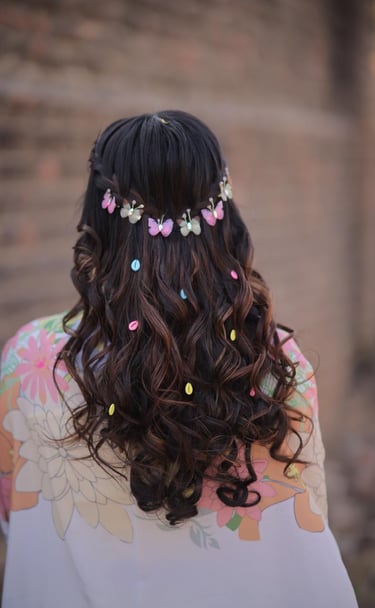 Whimsical open curls hairstyle decorated with colorful butterfly clips for engagement or pre-wedding