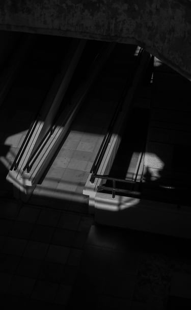 Black and white architectural photography with dramatic shadows and geometric lighting Unseen Spaces