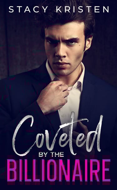 A man in a black suit jacket and white button down shirt, giving a smoldering look.