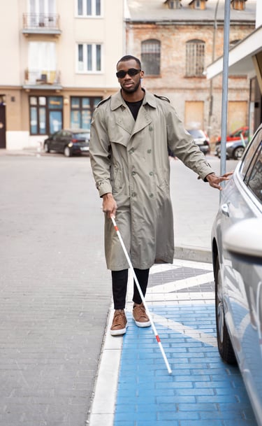 man with glaucoma wearing glare shields crossing street with cane for the blind independently