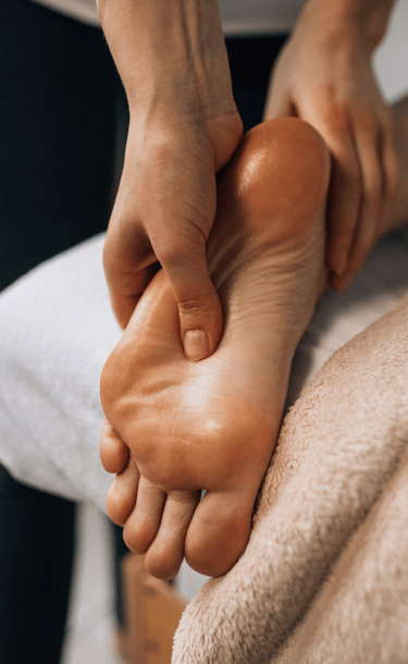 a person is getting a foot massage