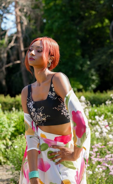 a woman model in a floral print dress and a black top