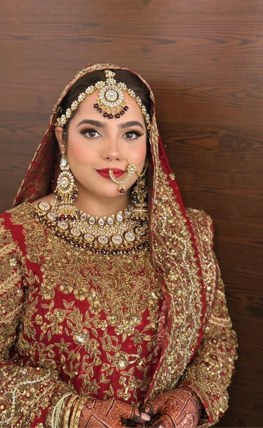 a bride in a red and gold bridall, best makeup artist in dubai , bridal makeup Dubai best