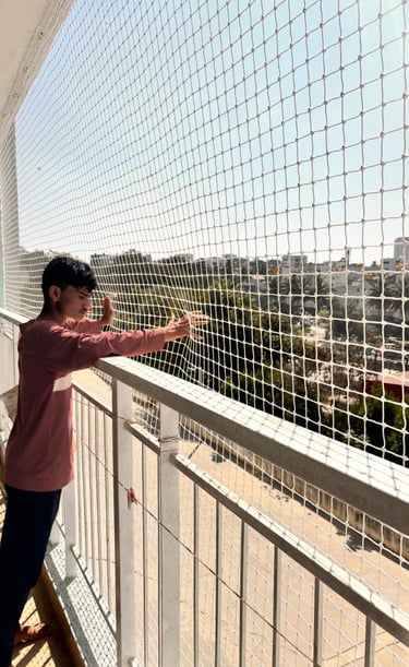 Close-up of tightly woven safety netting protecting an open apartment area, showcasing craftsmanship