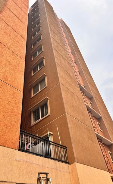 Wide shot of a residential apartment with pigeon nets fitted in Hebbal.