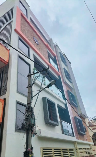 Wide shot of a residential building in Pune with anti-pigeon nets installed on all windows.