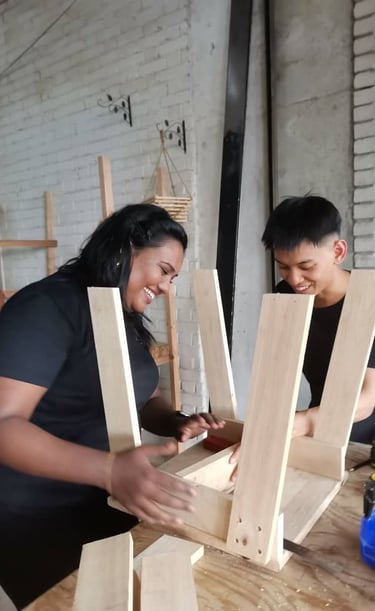 A pair working on a classroom chair which will be donated to a school after the workshop