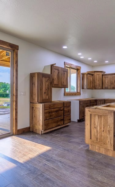 custom wood floors and cabinets in kitchen by Saddle Horn Custom Homes
