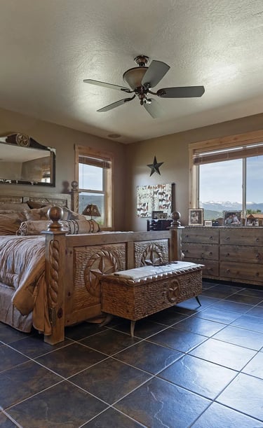 a bedroom with a bed and a dog and mountains outside