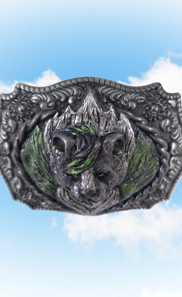 Vintage ornate skunk belt buckle with green enamel accents set against a blue sky background.