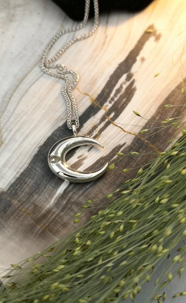 14kt white gold crescent moon pendant with flush set white sapphire